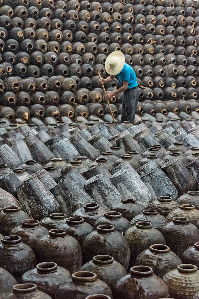 Man in the middle of big pile of wine jars-Wuxi-Jiangsu Province-China
